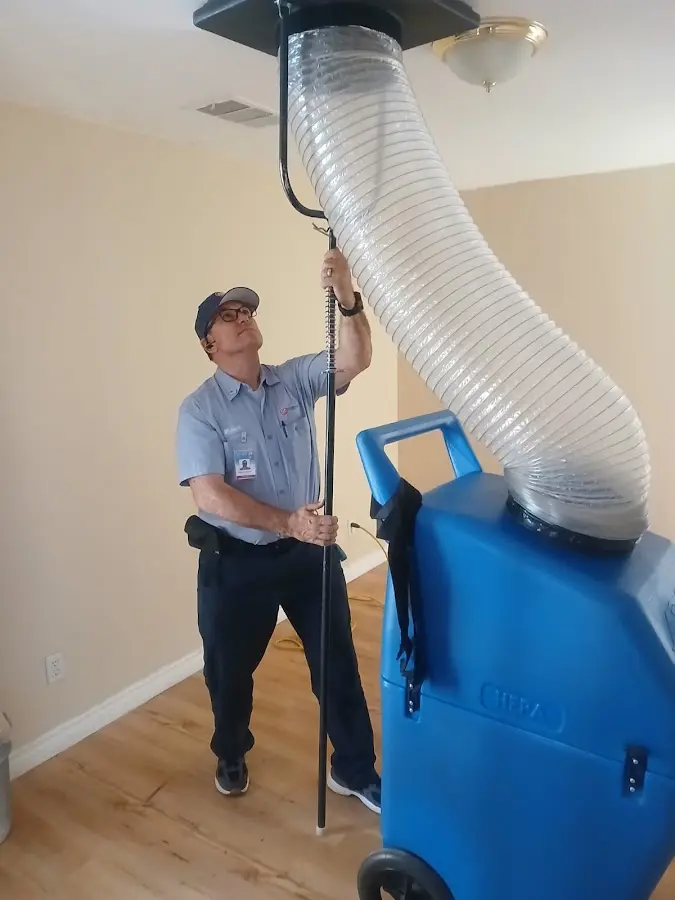 Furnace Tune-Up technician using HEPA equipment in Montevideo
